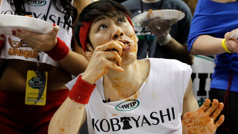 FILE - This Feb. 3, 2012 file photo shows Japanese competitive eater Takeru Kobayashi eating...