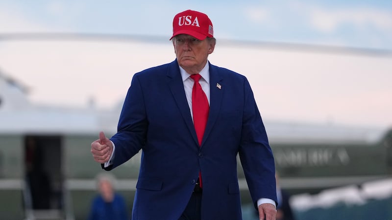 President Donald Trump walks from Marine One to board Air Force One, Friday, Oct. 16, 2026, at...